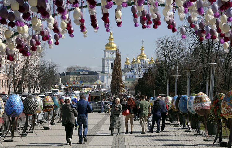 People visit an art installation of Easter eggs, in Kiev, Ukraine on April 10, 2018. Vladislav Pleshakov, a journalist from the privately owned television channel 1+1, was assaulted in an upscale neighborhood near Kiev on April 21, 2018, while filming for an investigative report, according to reports. (AP/Efrem Lukatsky)