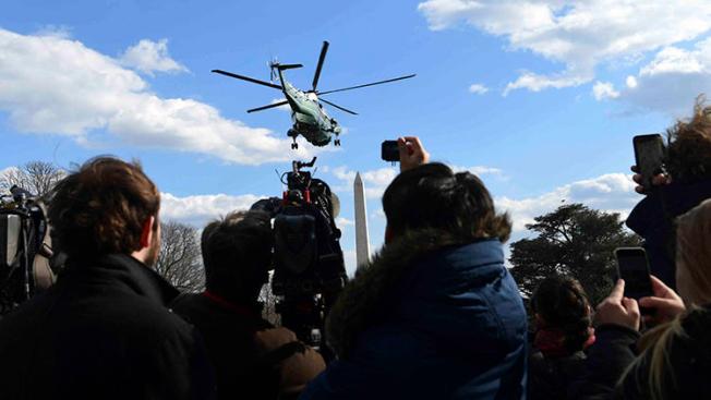 Journalists watch as Marine One, with President Donald Trump on board, lifts off from the White House in March 2018. An already hostile environment for the U.S. press has worsened since Trump came to power. (AP/Susan Walsh)