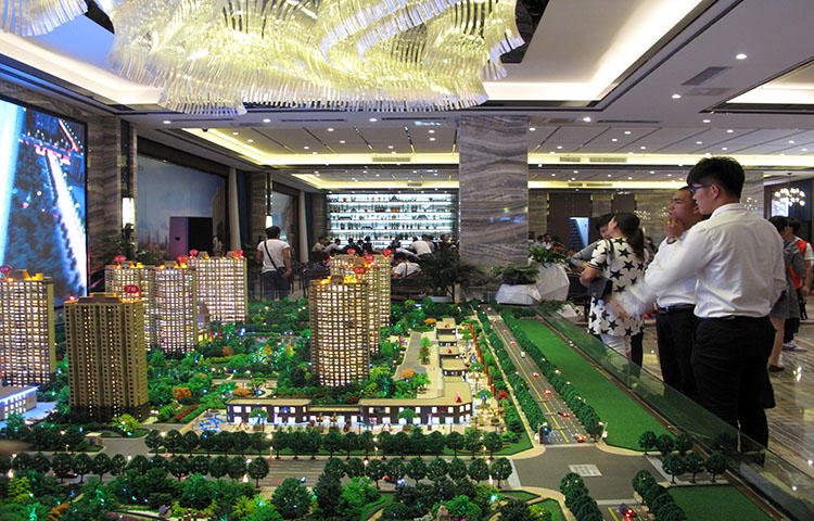 Models of residential buildings at a sales center in Henan province, China in September 2016. A television crew was assaulted in Kaifeng City in Henan province while reporting on a real estate dispute, according to reports. (Reuters/Yawen Chen)