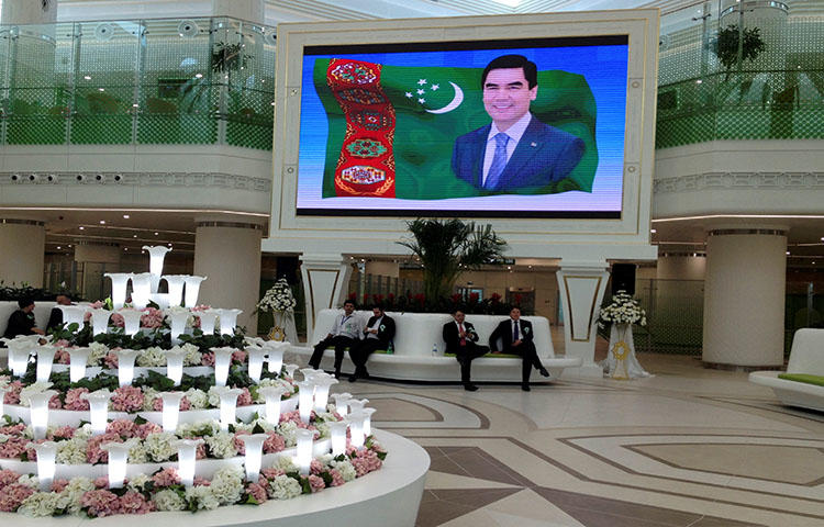 An airport in Ashgabat features a portrait of Turkmen President Kurbanguly Berdymukhamedov in September 2016. Turkmen authorities threatened and detained journalist Soltan Achilova on May 9, 2018, as she was attempting to take pictures. (Reuters/Marat Gurt)