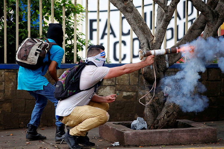 Un manifestante dispara un mortero casero contra la policía antimotines durante una protesta contra el gobierno del presidente Daniel Ortega en Managua, Nicaragua, el 28 de mayo de 2018. Civiles atacaron e incendiaron una radioemisora progubernamental en Managua el 28 de mayo. (Oswaldo Rivas / Reuters)