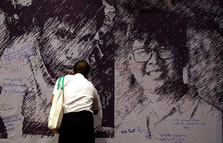 Messages of support are left on a poster depicting detained Reuters reporters Wa Lone and Kyaw Soe Oo, at a press freedom event in Yangon, Myanmar, on May 1. (Reuters/Ann Wang)