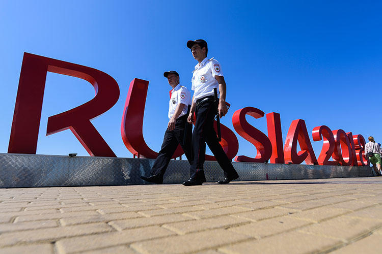 Security personnel walk near the Fisht Olympic Stadium in Sochi on June 12, 2018, two days ahead of the Russia 2018 World Cup football tournament. An imprisoned Russian editor was wounded and hospitalized in Sochi on June 18. (AFP/Jewel Samad)