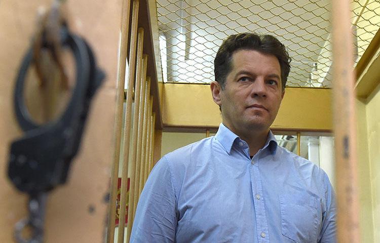 Ukrainian journalist Roman Sushchenko stands inside a defendants' cage during a November 28, 2016, hearing at a court in Moscow. Sushchenko was sentenced to 12 years in prison for espionage by a Moscow city court on June 4, 2018. (Vasily Maximov/AFP)