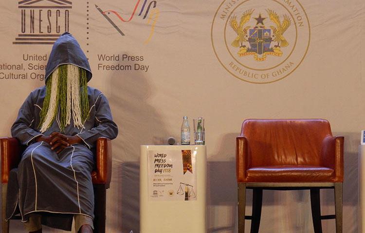 Ghanaian investigative journalist Anas Aremeyaw Anas participates in disguise on a panel at the UNESCO World Press Freedom Day event in Accra, Ghana, on May 3, 2018. One month later, Ghanaian member of parliament, Kennedy Agyapong, has been threatening Anas and those perceived as close to his undercover investigative film about corruption and football in Ghana. (CPJ/Jonathan Rozen)