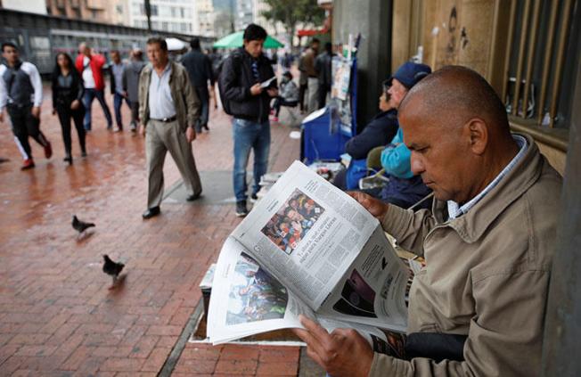 A man reads a newspaper in Bogotá in May. An international court has ordered Colombia to properly pursue justice for a radio journalist killed in 1998. (Reuters/Jaime Saldarriaga)