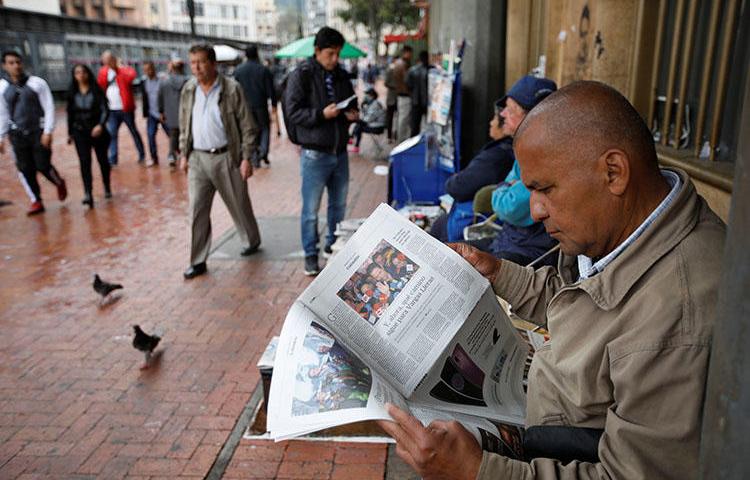 A man reads a newspaper in Bogotá in May. An international court has ordered Colombia to properly pursue justice for a radio journalist killed in 1998. (Reuters/Jaime Saldarriaga)