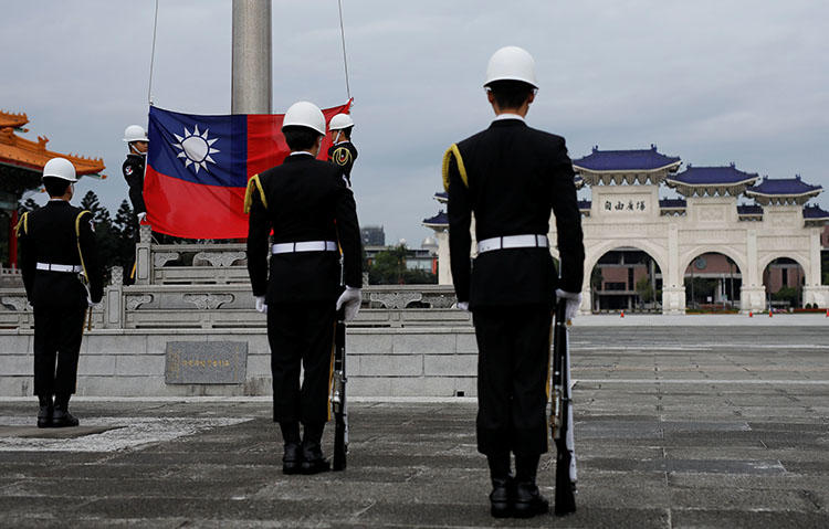Guards attend a flag-raising ceremony at Taipei's Chiang Kai-shek Memorial Hall in March 2018. Taiwan's parliament is considering a draft bill to penalize 'fake news.' (Reuters/Tyrone Siu)