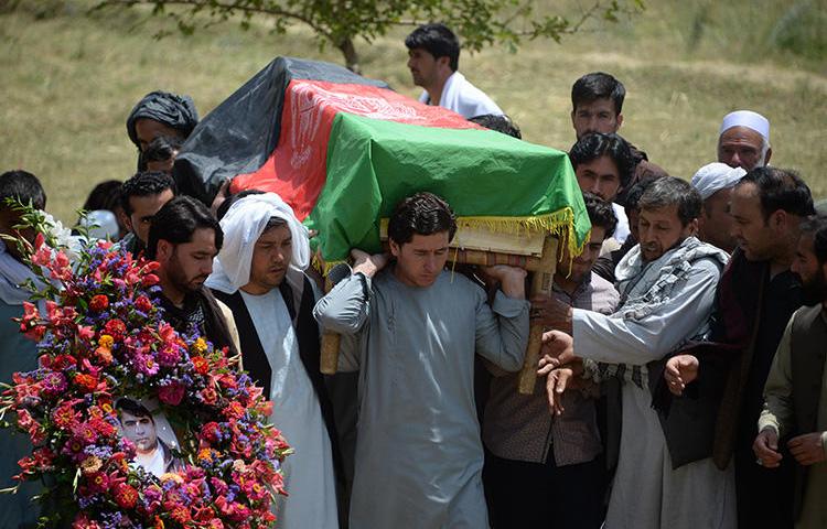 Relatives, colleagues, and friends carry the coffin at a ceremony for AFP driver Mohammad Akhtar in Kabul, Afghanistan, on July 23, 2018, one day after he was killed in a suicide attack in the Afghan capital. (AFP/Noorullah Shirzada)