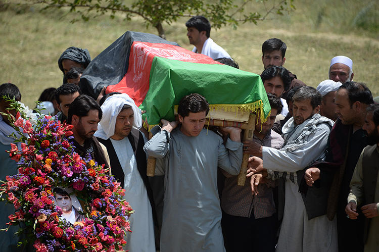 Relatives, colleagues, and friends carry the coffin at a ceremony for AFP driver Mohammad Akhtar in Kabul, Afghanistan, on July 23, 2018, one day after he was killed in a suicide attack in the Afghan capital. (AFP/Noorullah Shirzada)