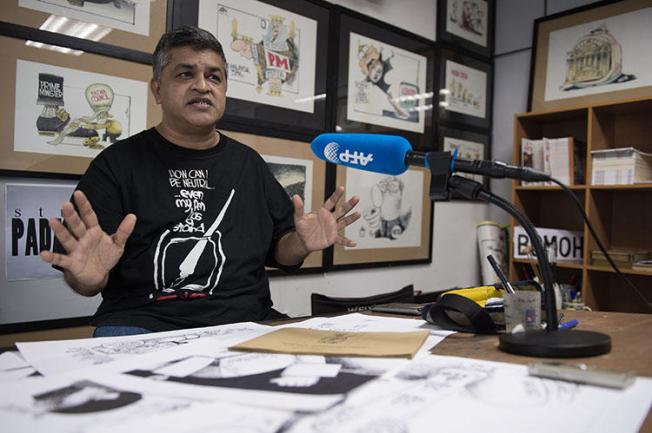 Political cartoonist Zunar, pictured in his Kuala Lumpur office in 2015. A court in Malaysia dropped nine sedition charges against Zunar. (AFP/Mohd Rasfan)