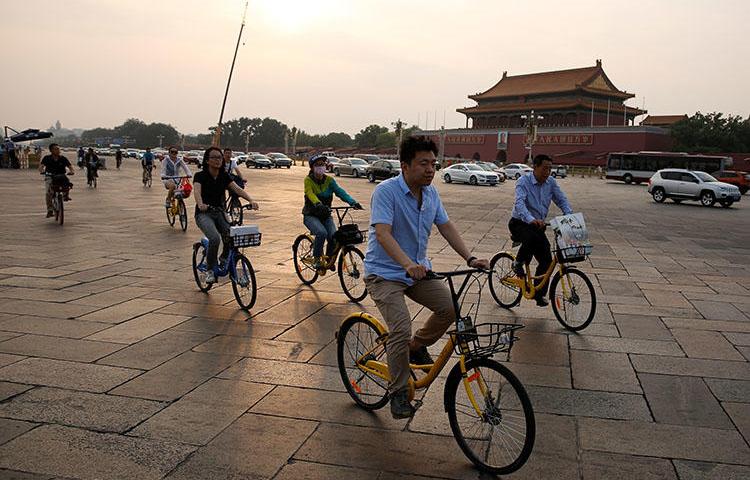 Cyclists cross Tiananmen Square in Beijing, China on June 16, 2017. A Sichuan province court on July 13, 2018, sentenced Chinese freelance political cartoonist Jiang Yefei to prison for six years and six months on charges of