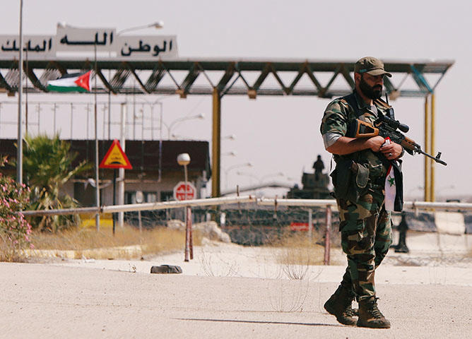 A Syrian soldier at the Nasib border crossing with Jordan in Deraa, Syria on July 7, 2018. At least 70 journalists and media workers are caught in Quneitra between advancing forces aligned with Syrian President Bashar al-Assad and the closed borders of Israel and Jordan, according to CPJ research. (Reuters/ Omar Sanadiki)