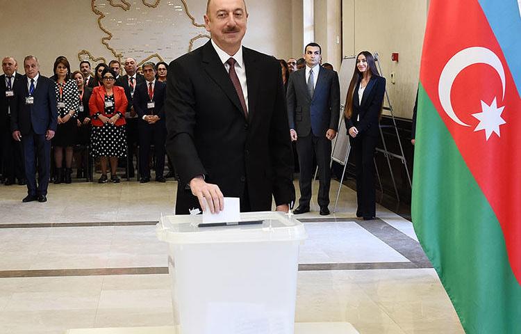 Azerbaijani President Ilham Aliyev casts his vote during the presidential election in Baku, Azerbaijan, on April 11, 2018. Azerbaijani journalist Afgan Sadygov was sentenced to 30 days in jail on July 7. (AZERTAC/Vugar Amrullayev/Pool via Reuters)