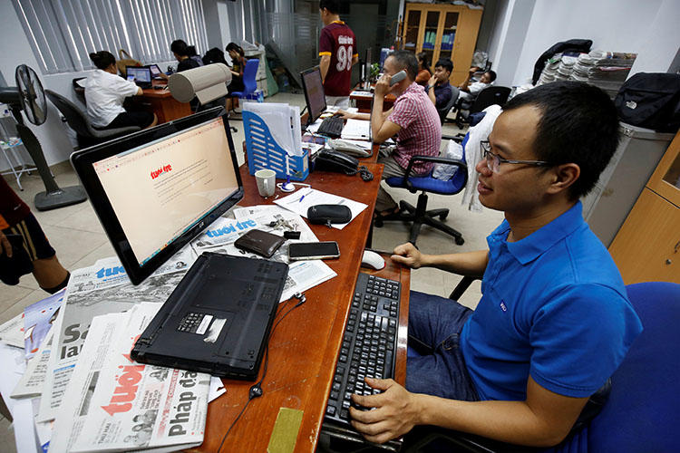 A journalist shows the banned online edition of Tuoi Tre at the newspaper's office in Hanoi, Vietnam, on July 17, 2018. (Reuters/Nguyen Huy Kham)
