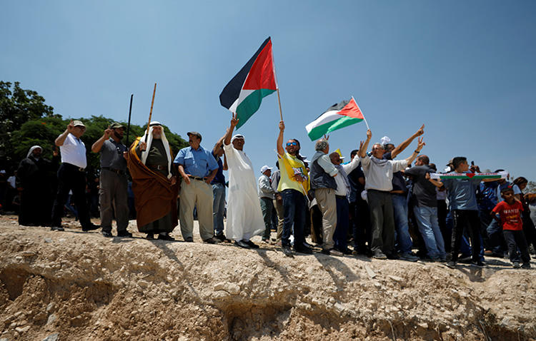 Palestinians protest against Israel's plans to demolish the Bedouin village of Khan al-Ahmar, in the occupied West Bank, on July 13, 2018. Israeli forces arrested and detained a Palestine TV reporter in the West Bank on August 15. (Reuters/Mohamad Torokman)