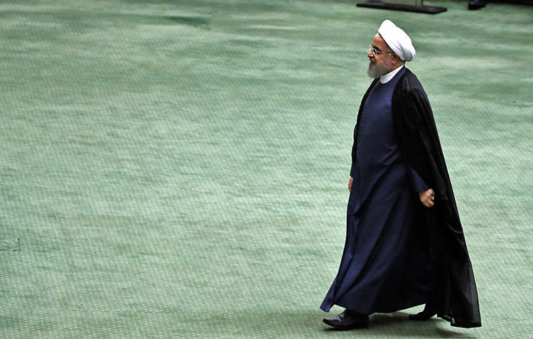 President Hassan Rouhani arrives at the Iranian parliament in Tehran on August 28. The country's courts recently ordered at least seven journalists to be jailed for lengthy sentences and to be flogged for their coverage of a religious protest. (AFP/Atta Kenare)