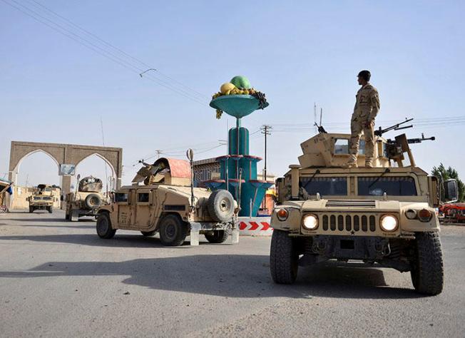 Afghan security personnel patrol in Ghazni city. Fighting between the Taliban and Afghan forces in and around Ghazni has left at least 20 civilians dead since August 10, the AP reported. (AP/Mohammad Anwar Danishyar)