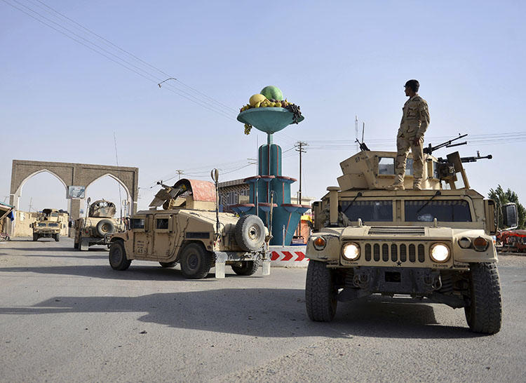 Afghan security personnel patrol in Ghazni city. Fighting between the Taliban and Afghan forces in and around Ghazni has left at least 20 civilians dead since August 10, the AP reported. (AP/Mohammad Anwar Danishyar)