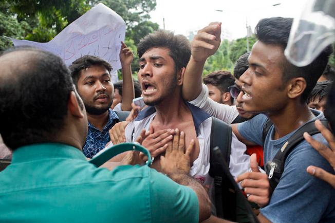 Bangladeshi students attempt to break a police barricade during a protest in Dhaka on August 1. More than a dozen journalists have been attacked covering the nationwide protests. (AP/A. M. Ahad)