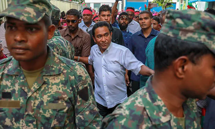 President Yameen, center, surrounded by his body guards in the capital, Malé, in February 2018. The president was criticized today for comments he made about missing Maldives journalist Rilwan. (AP/Mohamed Sharuhaan/File)