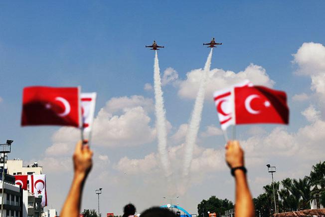 Turkish aircraft fly over a parade in the Turkish Cypriot northern part of the divided city of Nicosia, Cyprus on July 20, 2018. The parade marked the 1974 Turkish invasion of Cyprus. (Reuters/Yiannis Kourtoglou)