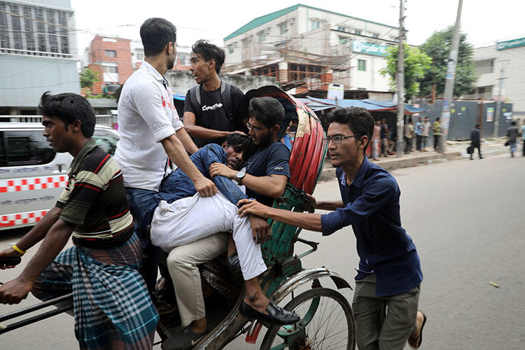 Students take an injured fellow to the hospital during clashes with unidentified assailants while they are protesting over recent fatal traffic accidents in Dhaka, Bangladesh, August 4, 2018. (Reuters/Mohammad Ponir Hossain)