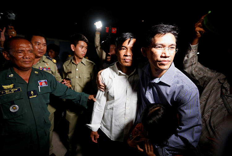 Uon Chhin, left, and Yeang Sothearin, former journalists for Radio Free Asia, leave prison in Cambodia after being freed on bail. Both still face espionage charges. (Reuters/Samrang Pring)