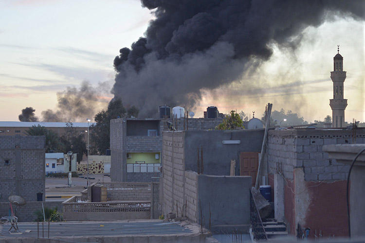 In this January 2014 image, smoke billows from buildings in the Libyan city of Sabha. A journalist from the city, which is still experiencing unrest, was abducted and killed in July 2018. (Reuters/Saddam Alrashd)