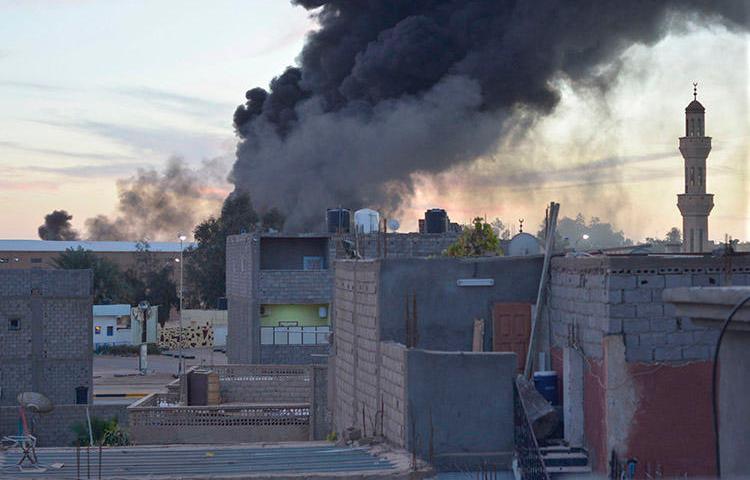 In this January 2014 image, smoke billows from buildings in the Libyan city of Sabha. A journalist from the city, which is still experiencing unrest, was abducted and killed in July 2018. (Reuters/Saddam Alrashd)