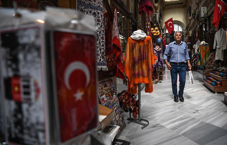 A man shops at the gallery on August 16, 2018 near the Istiklal avenue, at Beyoglu district, in Istanbul. (AFP/Ozan Kose)