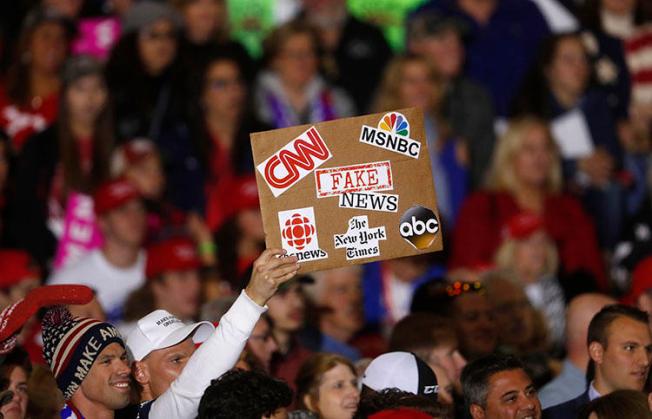An audience member protests the news media during a President Donald Trump campaign rally in Washington Township, Michigan, on April 28, 2018. (AP/Paul Sancya)