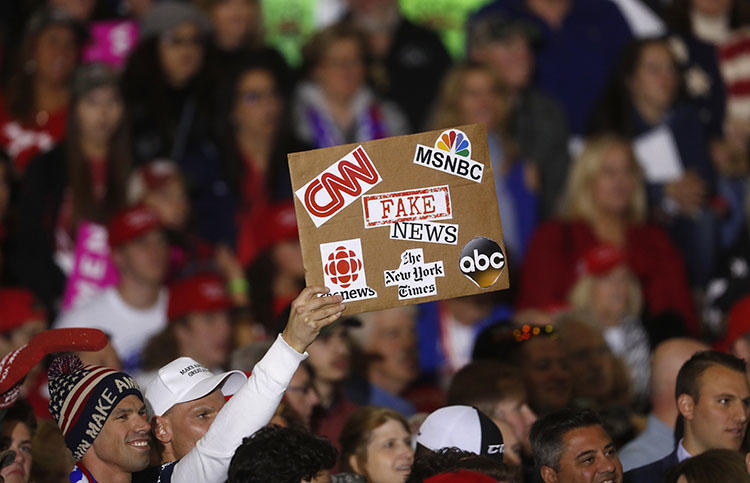 An audience member protests the news media during a President Donald Trump campaign rally in Washington Township, Michigan, on April 28, 2018. (AP/Paul Sancya)