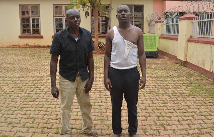 Journalists Herbert Zziwa, right, and Ronald Muwanga are pictured shortly after being released from Gulu Central Police station. (Daily Monitor/Julius Ocungi)