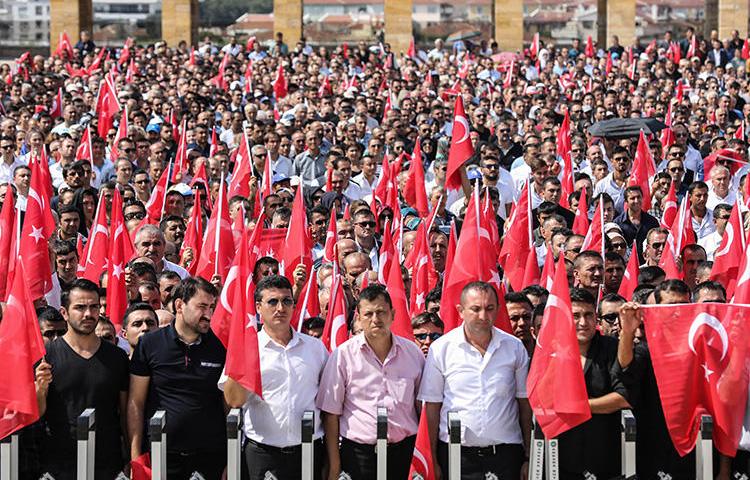 People hold Turkish flags during a ceremony marking the 96th anniversary of Victory Day, commemorating a decisive battle in the Turkish War of Independence, in Ankara on August 30, 2018. (AFP/Adem Altan)