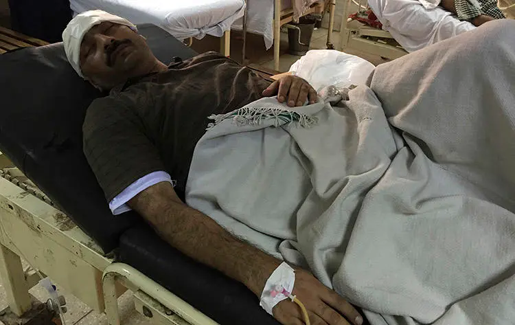 Investigative reporter Ahmad Noorani, pictured in a hospital after being attacked in Islamabad in October 2017. (AP/B.K. Bangash)