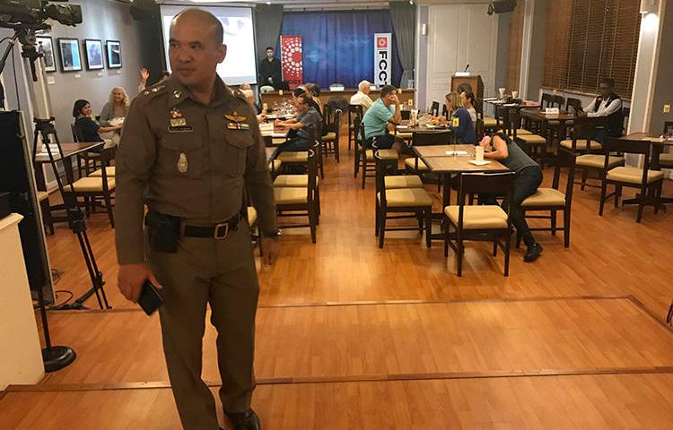 A Thai policeman stands inside the Foreign Correspondents' Club of Thailand on September 10, 2018, during a forum to discuss alleged human rights abuses by the military junta in Myanmar. The discussion was shut down by the Thai authorities. (AP Photo/Tassanee Vejpongsa)