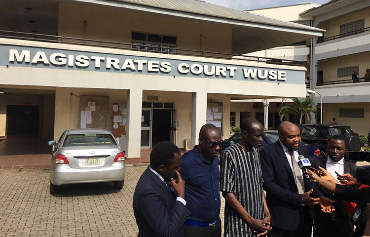 Jones Abiri, pictured third from left with his legal team, speaks to the media on September 5. An Abuja court has dismissed the case against the Nigerian journalist. (CPJ/Jonathan Rozen)