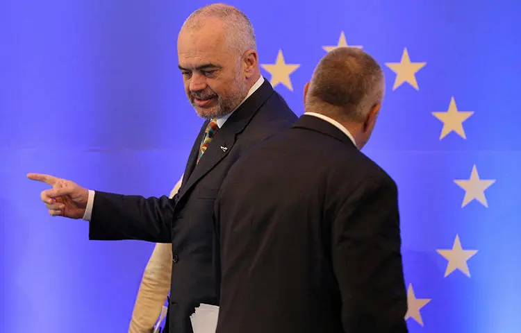 Bulgarian Prime Minister Boyko Borissov stands by the EU flag at a conference in Sofia, in December 2017. Police in Bulgaria briefly detained two journalists investigating allegations of fraud involving EU funds. (Reuters/Stoyan Nenov)