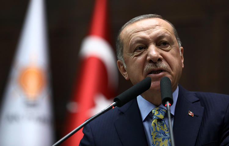 President Recep Tayyip Erdoğan addresses members of Turkey's parliament in Ankara on October 16, 2018. A court convicted three journalists of insulting the president in the pro-Kurdish daily Özgür Gündem. (AFP/Adem Altan)