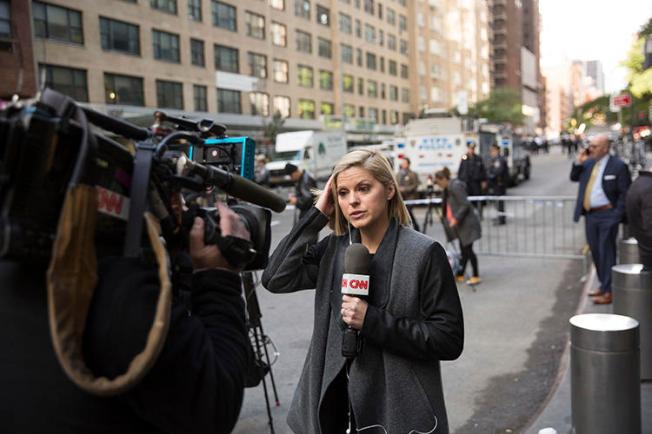 CNN correspondent Kate Bolduan reports from outside the Time Warner Building in New York City on October 24, as police remove an explosive device from the CNN offices. (AP/Kevin Hagen)