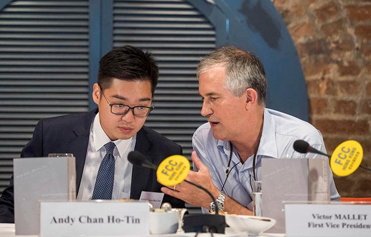 In this August 14, 2018, photo, Victor Mallet, Financial Times Asia news editor, right, speaks with Andy Chan, founder of the Hong Kong National Party, at the Foreign Correspondents Club in Hong Kong. Hong Kong's government has declined to renew Mallet's work visa. (AP)