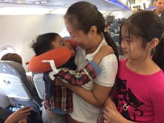 Vietnamese blogger Nguyen Ngoc Nhu Quynh, known by her pen name "Mother Mushroom," with her two children on a plane on the way to the U.S. after being freed from prison in Vietnam on October 17, 2018. (Family photo)