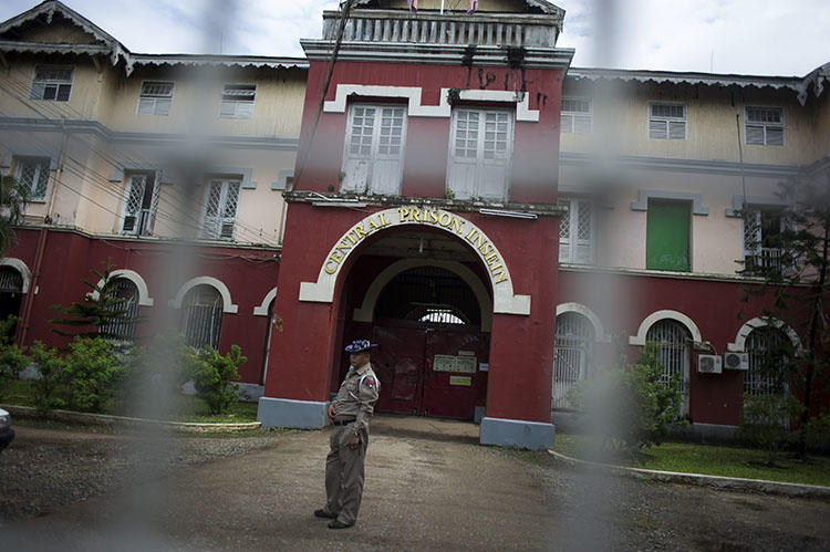 An officer stand guards before Insein prison in Yangon, Myanmar. Three journalists from Eleven Media were remanded to the prison after raising questions about public spending in Yangon. (Ye Aung Thu/AFP)