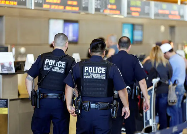 Customs and Border Protection agents pictured at Los Angeles International Airport in January 2017. The agency’s power to search electronic devices without warrant has serious implications for press freedom. (Reuters/Patrick T. Fallon)