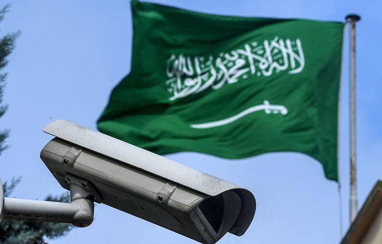 A Saudi Arabia flag and a surveillance camera are seen in the backyard of the Saudi Arabian consulate in Istanbul. Saudi actors are believed to have spied on phone calls and messages between murdered journalist Jamal Khashoggi and his friend, Saudi dissident Omar Abdulaziz. (AFP/Ozan Kose)