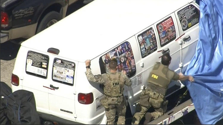 In this video screen shot, FBI agents cover a van being transported from Plantation, Florida, on October 26, 2018, that federal agents and police officers have been examining in connection with package bombs sent to CNN and high-profile critics of President Donald Trump. (WPLG-TV via AP)