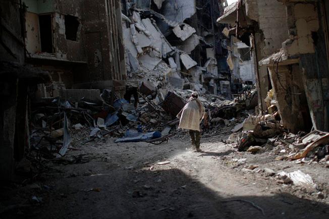 A man walks through rubble in Damascus in October 2018, caused by years of war. Safety remains a key concern for Syrian journalists. (AP/Hassan Ammar)