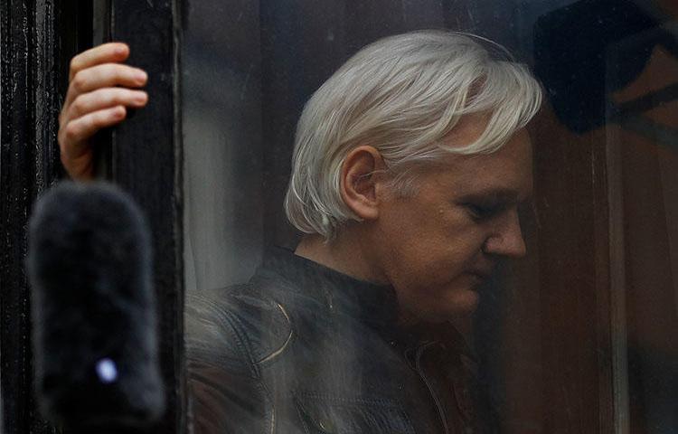 WikiLeaks founder Julian Assange is seen on the balcony of the Ecuadoran Embassy in London, U.K., on May 19, 2017. (Reuters/Peter Nicholls)