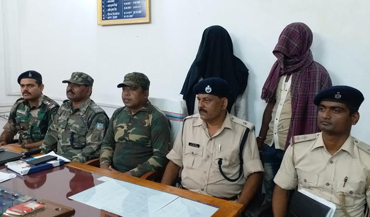 Two suspects, with their faces covered, are brought out at a press conference on the killing of Indian journalist Chandan Tiwari. (Handout)